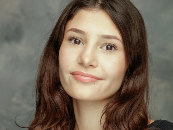 Person with brown hair and eyes headshot