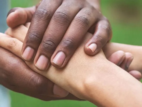 Close up of two people's hands holding eachother