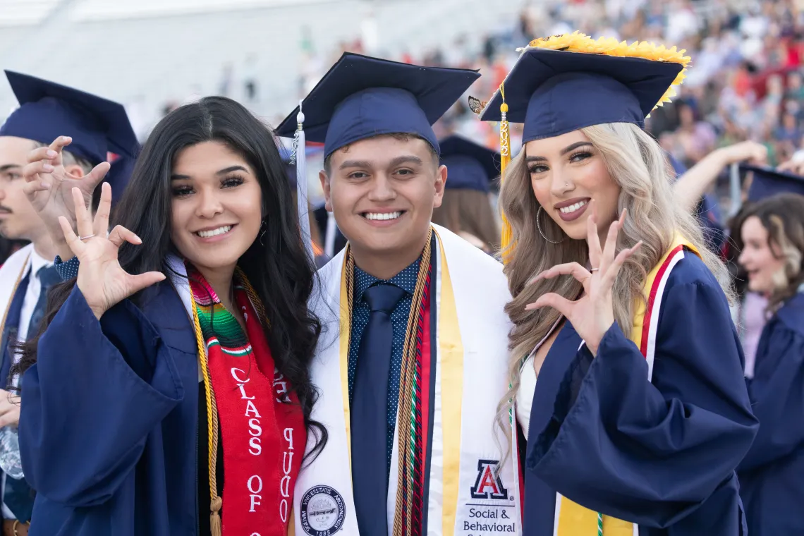 3 Students at Graduation