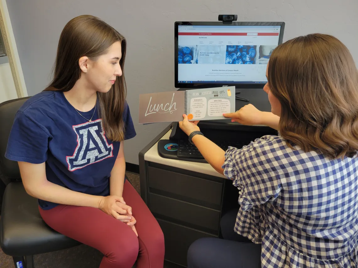 Student and dietitian looking at a lunch recipe