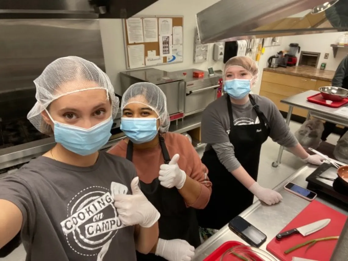 Students in kitchen. 