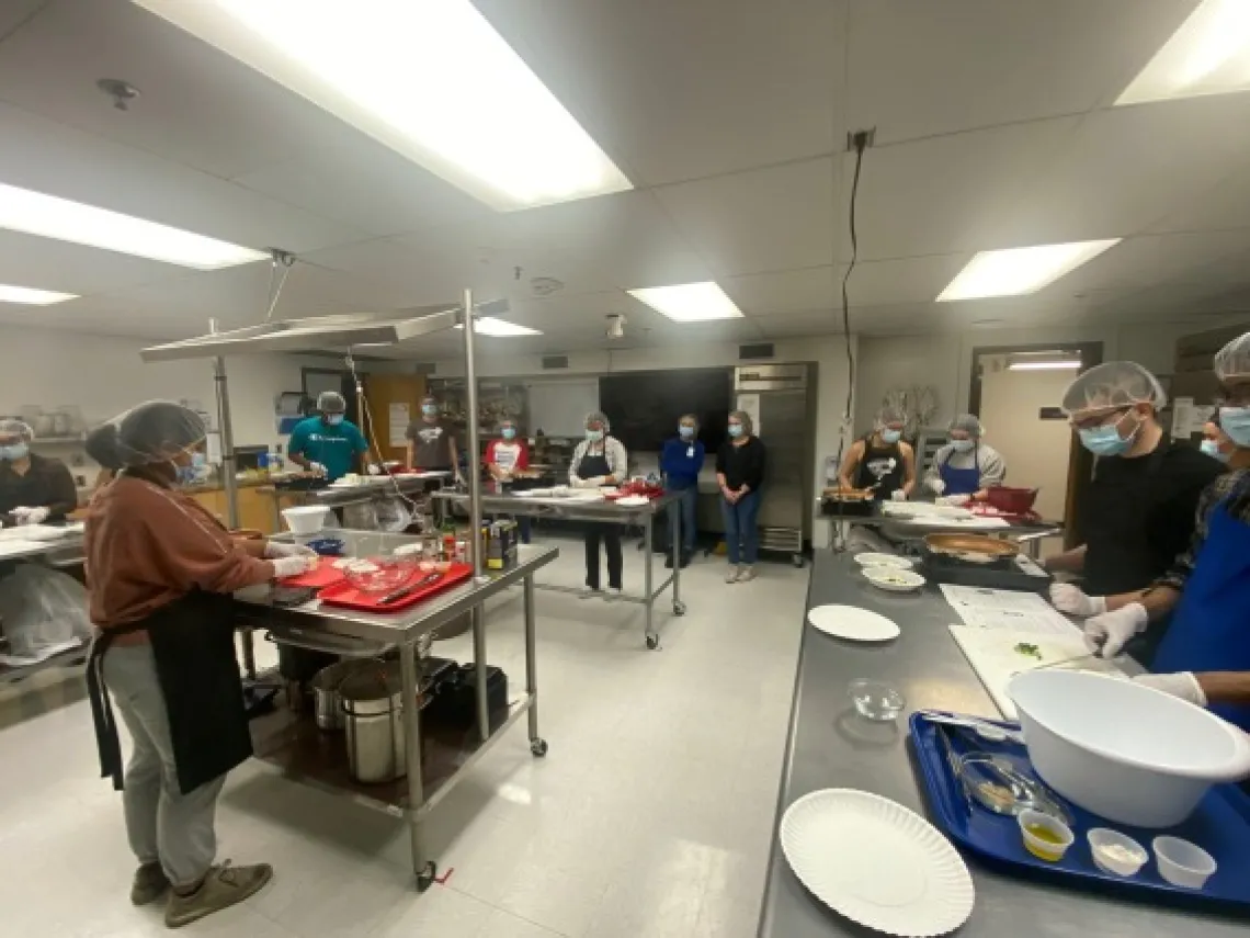 Students cooking in kitchen.