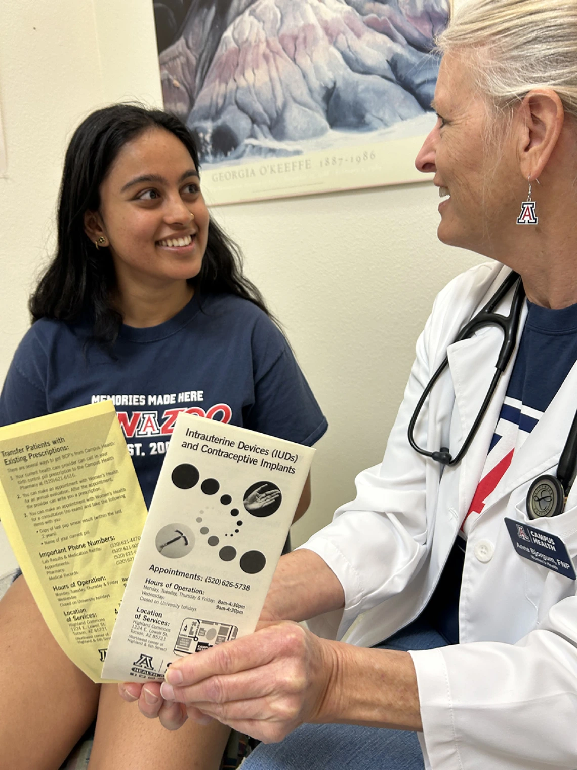 student and provider looking at women's health brochures