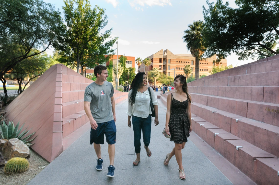 three students walking on campus
