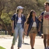 Group of three students walking around campus. 